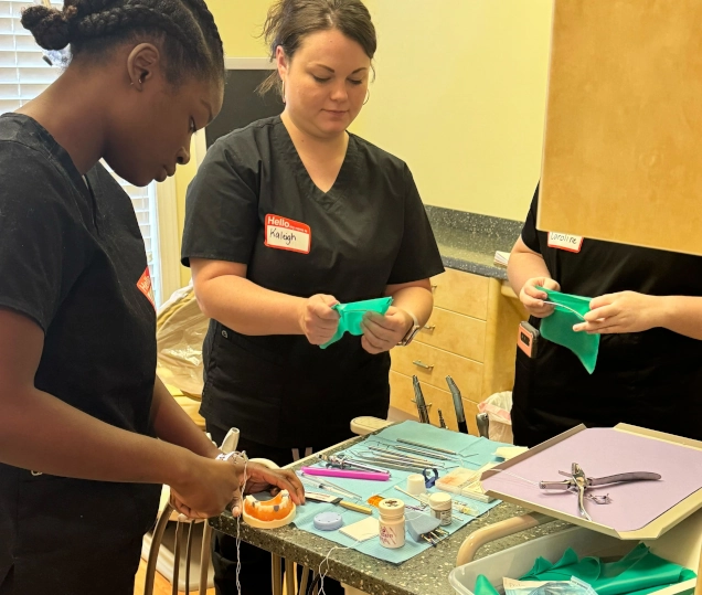 Dental Assistant School students training with dental impressions in class